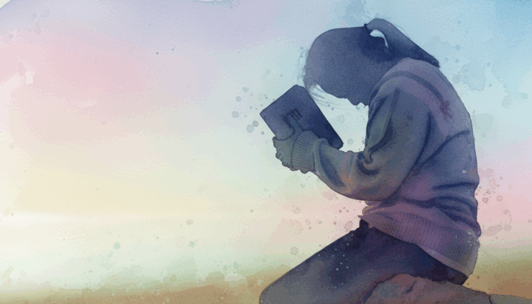 woman on knees praying with a bible